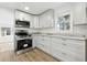 Modern kitchen with white cabinets, stainless steel appliances, and light countertops at 6301 Hobson Ne St, St Petersburg, FL 33702