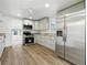 A well-equipped kitchen featuring stainless steel appliances, white cabinets, and modern fixtures at 6301 Hobson Ne St, St Petersburg, FL 33702