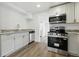 Modern kitchen equipped with stainless steel appliances, granite countertops, and white cabinets at 6301 Hobson Ne St, St Petersburg, FL 33702