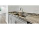 Close up of kitchen sink and countertop with granite surface and stainless steel faucet at 6301 Hobson Ne St, St Petersburg, FL 33702