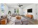 Bright living room with neutral walls, modern furniture, stylish rug, and ceiling fan at 6301 Hobson Ne St, St Petersburg, FL 33702