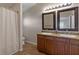 Bathroom featuring a double sink vanity, granite countertops, and a shower with curtain at 7001 Interbay Blvd # 219, Tampa, FL 33616