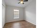 Bright bedroom featuring light-colored walls, hardwood floors, a ceiling fan, and a window at 7001 Interbay Blvd # 219, Tampa, FL 33616