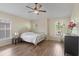 Bedroom with a metal frame bed, wood floors, a nightstand, and natural lighting at 7001 Interbay Blvd # 219, Tampa, FL 33616