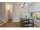 Dining area with wood floors, a modern chandelier, and natural light at 7001 Interbay Blvd # 219, Tampa, FL 33616