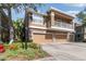 Stylish multi-level condo featuring stone accents, a second-story balcony, and an attached two-car garage at 7001 Interbay Blvd # 219, Tampa, FL 33616