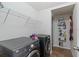 Functional laundry room featuring modern washer and dryer, with storage shelving for supplies at 7001 Interbay Blvd # 219, Tampa, FL 33616