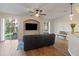 Bright living room featuring hardwood floors, ceiling fan, large windows, and backyard views at 7001 Interbay Blvd # 219, Tampa, FL 33616