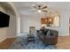 Open concept living room with a blue rug, ceiling fan, and view of the kitchen at 7001 Interbay Blvd # 219, Tampa, FL 33616