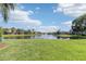 Scenic view of a pond surrounded by green grass and neighborhood homes on a sunny day at 7001 Interbay Blvd # 219, Tampa, FL 33616