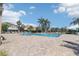 Community pool surrounded by lounge chairs and palm trees at 7001 Interbay Blvd # 219, Tampa, FL 33616