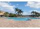 Community pool featuring a spacious deck with ample seating, palm trees and sunny skies at 7001 Interbay Blvd # 219, Tampa, FL 33616