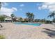 Picturesque community pool surrounded by lounge chairs, palm trees, and lush landscaping at 7001 Interbay Blvd # 219, Tampa, FL 33616