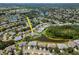A beautiful aerial view of a home nestled in a lush community with a serene pond view at 717 Manchester Woods Dr # 717, Sun City Center, FL 33573