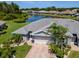 A lovely single Gathering home overlooking a pond, featuring palm trees and manicured landscaping in a peaceful residential neighborhood at 717 Manchester Woods Dr # 717, Sun City Center, FL 33573