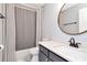 Cozy bathroom with a shower-tub combo, a dark-colored vanity, and modern fixtures at 717 Manchester Woods Dr # 717, Sun City Center, FL 33573