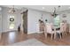 Dining area with hardwood floors, sliding barn door, modern chandelier, and a table with seating for six at 717 Manchester Woods Dr # 717, Sun City Center, FL 33573