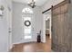 Inviting foyer with wood floors, decorative door, and sliding barn door leading to another room at 717 Manchester Woods Dr # 717, Sun City Center, FL 33573