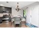Charming kitchen and dining area, including hardwood floors, modern cabinetry, and stainless steel appliances at 717 Manchester Woods Dr # 717, Sun City Center, FL 33573