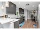 Modern kitchen with grey cabinets, stainless steel appliances, and white subway tile backsplash offers both style and functionality at 717 Manchester Woods Dr # 717, Sun City Center, FL 33573