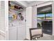 Efficient laundry closet with washer, dryer, shelving, and louvered doors, adjacent to a window at 717 Manchester Woods Dr # 717, Sun City Center, FL 33573