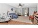 The bright living room is decorated with hardwood floors, ceiling fan and cozy blue couches at 717 Manchester Woods Dr # 717, Sun City Center, FL 33573