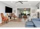Bright living room with hardwood floors, fan, and comfortable blue couches is the perfect place to relax or entertain guests at 717 Manchester Woods Dr # 717, Sun City Center, FL 33573
