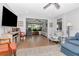 Bright living room with hardwood floors, fan, and comfortable blue couches is the perfect place to relax or entertain guests at 717 Manchester Woods Dr # 717, Sun City Center, FL 33573