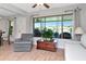 Cozy living room features a large window and comfortable seating at 717 Manchester Woods Dr # 717, Sun City Center, FL 33573