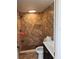 Beautifully tiled walk-in shower featuring stone-look tile and a built-in shelf, with modern fixtures and plenty of space at 7321 W Pocahontas Ave, Tampa, FL 33634