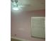 Bedroom features pink walls, ceiling fan, and a window with mini blinds at 7321 W Pocahontas Ave, Tampa, FL 33634