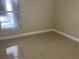 Bedroom features neutral walls, tile floor and a window for natural light at 7321 W Pocahontas Ave, Tampa, FL 33634
