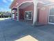 Stylish home's architectural details showcase decorative pillars, a red facade, and a spacious tiled entryway at 7321 W Pocahontas Ave, Tampa, FL 33634