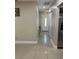 Inviting hallway featuring neutral walls, tile flooring, and a white front door at 7321 W Pocahontas Ave, Tampa, FL 33634