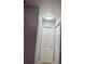 Hallway boasts updated light fixture, neutral paint and access to rooms at 7321 W Pocahontas Ave, Tampa, FL 33634