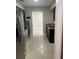 Contemporary kitchen features stainless steel appliances, dark cabinets, and tile flooring at 7321 W Pocahontas Ave, Tampa, FL 33634