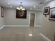 Inviting living room featuring neutral walls, tile floors, an ornate chandelier and wall art at 7321 W Pocahontas Ave, Tampa, FL 33634