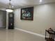 Spacious living room featuring neutral walls, tile floors, elegant chandelier and decorative wall art at 7321 W Pocahontas Ave, Tampa, FL 33634
