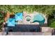 Aerial view of private backyard oasis with swimming pool, spa, and patio with blue umbrellas at 8200 31St N Ter, St Petersburg, FL 33710