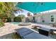 Backyard featuring a pool, hot tub, lounge chairs, and outdoor seating under a shade umbrella, perfect for relaxation and entertainment at 8200 31St N Ter, St Petersburg, FL 33710