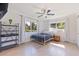 Bright bedroom featuring two windows, a ceiling fan, and stylish decor, creating a cozy and inviting atmosphere at 8200 31St N Ter, St Petersburg, FL 33710