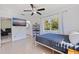 Bedroom with natural light, light hardwood floors, TV, and access to an en-suite bathroom and comfortable living area at 8200 31St N Ter, St Petersburg, FL 33710