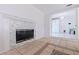 Cozy living room showcasing a modern tile fireplace and entrance to the dining area at 8200 31St N Ter, St Petersburg, FL 33710