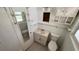 Compact bathroom with a small vanity, toilet, and mirrored medicine cabinet at 8211 Diagonal N Rd, St Petersburg, FL 33702