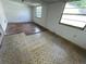 Bedroom with partial flooring, white walls and natural light from two windows at 8211 Diagonal N Rd, St Petersburg, FL 33702