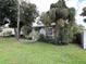 Charming house with lush landscaping around the front, including a mature palm tree at 8211 Diagonal N Rd, St Petersburg, FL 33702