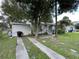 Modest home with a long driveway and mature trees in the front yard at 8211 Diagonal N Rd, St Petersburg, FL 33702