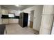 An open kitchen with stainless steel appliances and views of a vacant living room at 8211 Diagonal N Rd, St Petersburg, FL 33702