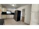 Spacious kitchen with tile flooring, stainless steel refrigerator, white cabinets and a window over the sink at 8211 Diagonal N Rd, St Petersburg, FL 33702