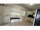 Cozy kitchen featuring white cabinets, neutral tile floors and ample natural light at 8211 Diagonal N Rd, St Petersburg, FL 33702